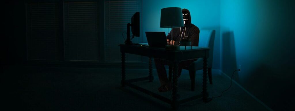 man siting facing laptop