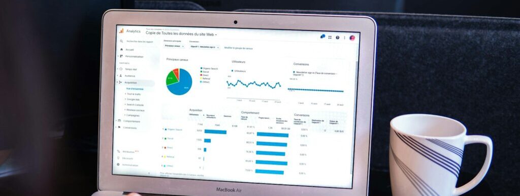 person using macbook pro on black table