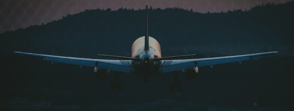 white airplane in the sky during night time