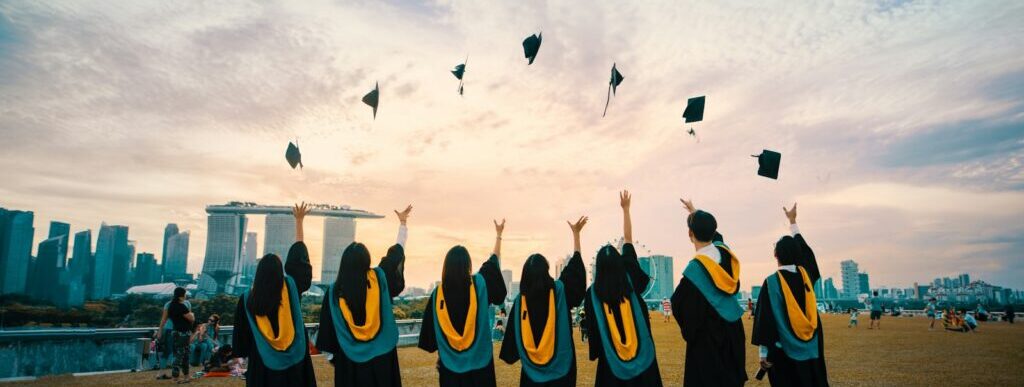 people throwing hats on air